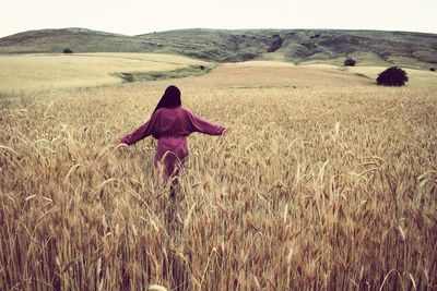 Rear view of woman on field