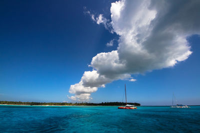 Sailboat in sea against blue sky