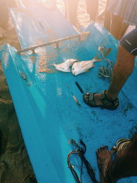Low section of people standing on tiled floor