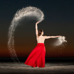 Full length of woman dancing on beach