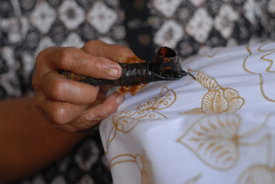 Cropped image of hand painting batik