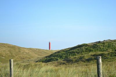 Lighthouse on grassy field