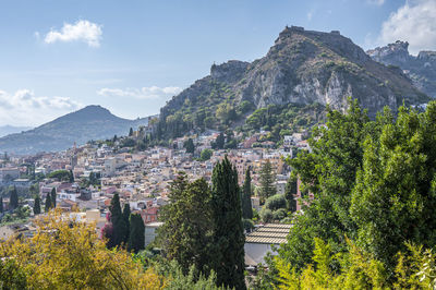 High angle view of townscape and mountains against sky