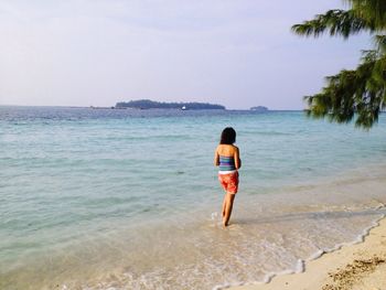 Full length of woman standing on beach