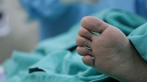 Close-up of hand holding baby feet