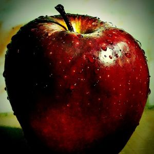 Close-up of apple on red leaf