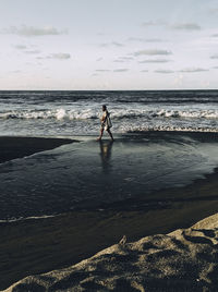 A father is looking for fish on the beach