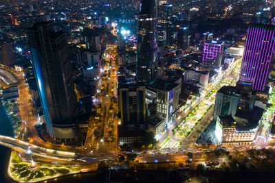 High angle view of illuminated buildings in city at night