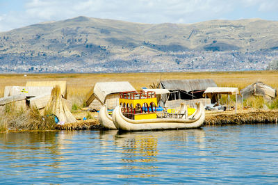 Graffiti on lake against mountain range