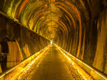 Walkway in illuminated tunnel