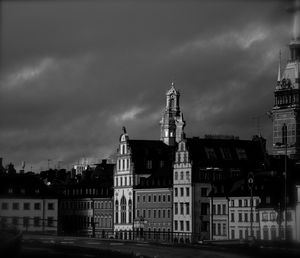 Buildings against cloudy sky