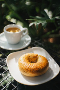 Homemade bagels and l coffee espresso on a gray chair natural background