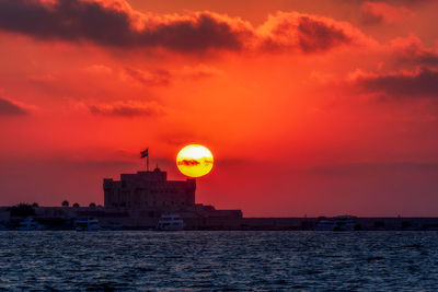 Scenic view of sea against romantic sky at sunset