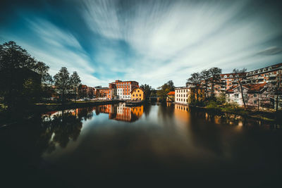 River amidst buildings against sky in city