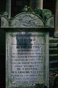 Close-up of text on metal at cemetery