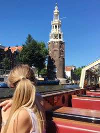 Side view of woman in city during sunny day