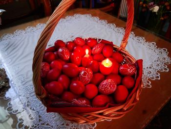High angle view of red easter eggs in basket on table