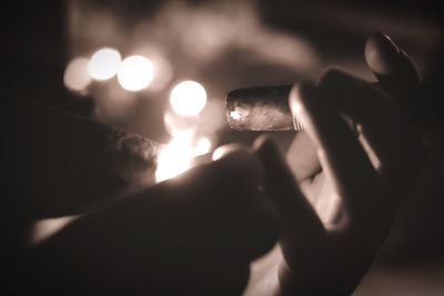 Close-up of hand holding cigarette