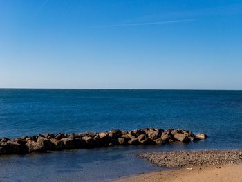 Scenic view of sea against clear blue sky