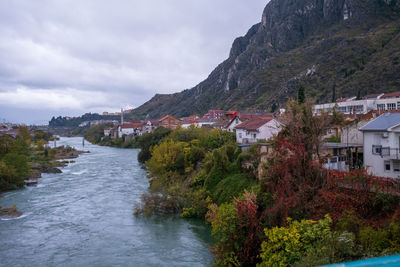 High angle view of townscape by sea against sky