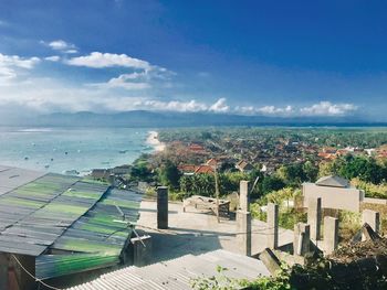 High angle view of townscape by sea against sky