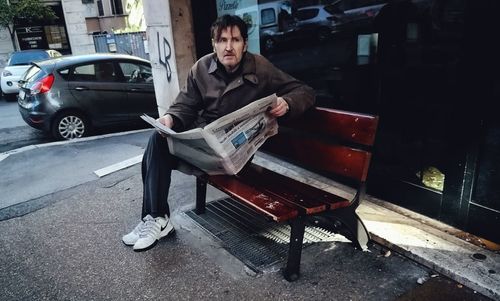 Full length of man sitting in car