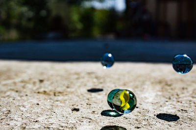 Close-up of a marbles on concrete 