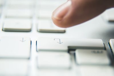 Close-up of hand using laptop