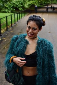 Portrait of smiling young woman standing outdoors