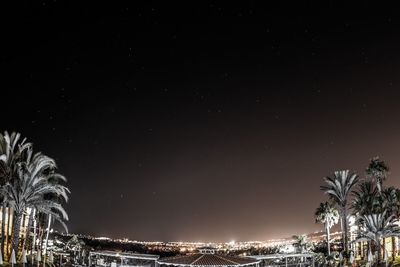 Illuminated cityscape against sky at night