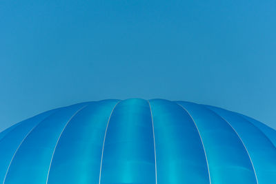 Low angle view of blue hot air balloon against blue sky