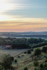 Scenic view of field against sky during sunset