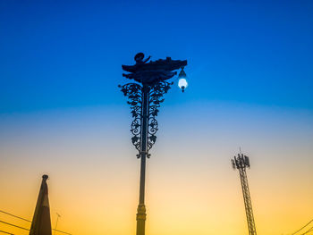 Low angle view of street light against sky at sunset