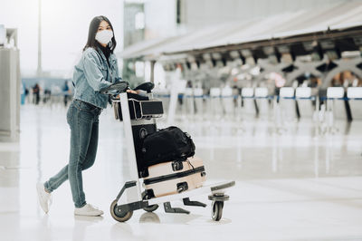 Side view of woman standing at airport