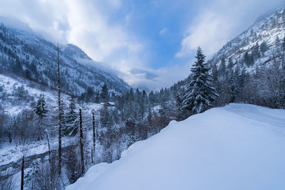 Scenic view of snow covered mountains against sky