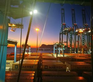 Illuminated sea against sky at night