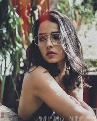 Portrait of young woman wearing sunglasses outdoors