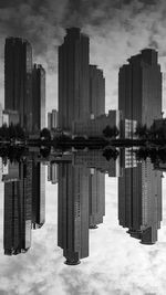 Digital composite image of modern buildings against sky in city