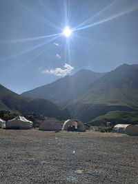 Scenic view of mountains against sky on sunny day