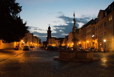 Buildings in city at sunset