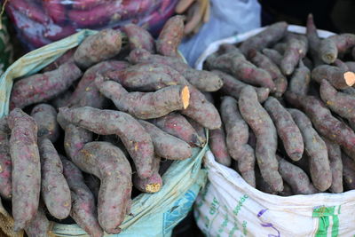 High angle view of sweet potatoes for sale at market stall