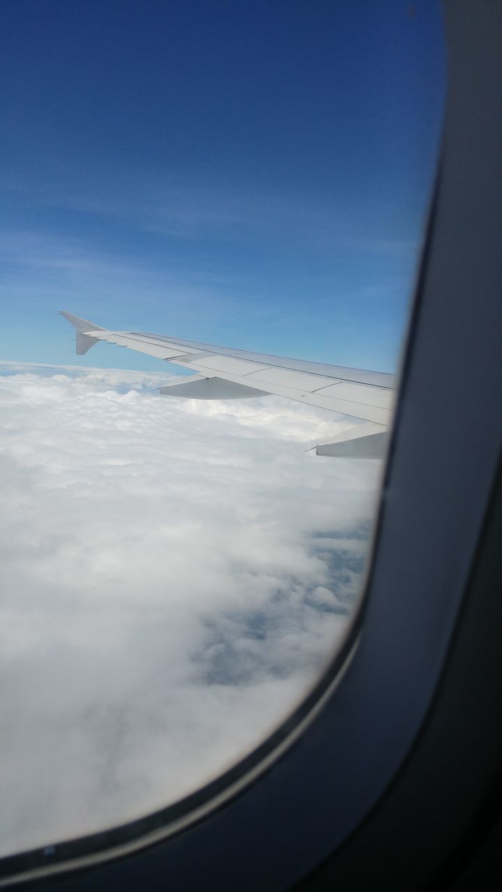 airplane, air vehicle, blue, flying, mode of transportation, transportation, sky, cloud, aircraft wing, travel, window, reflection, mid-air, aerial view, nature, journey, vehicle interior, no people, day, glass, motion, on the move, light, outdoors, vehicle, white, wing, scenics - nature, sunlight, cloudscape, transparent, beauty in nature, horizon, environment, looking, aircraft