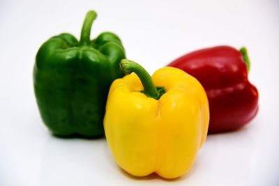 Close-up of yellow bell peppers on white background