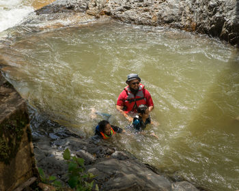 Asian family refreshing in the river in malaysia.