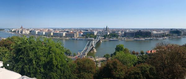 High angle view of river by city against clear sky