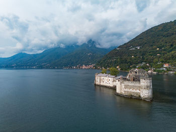 Scenic view of sea and mountains against sky