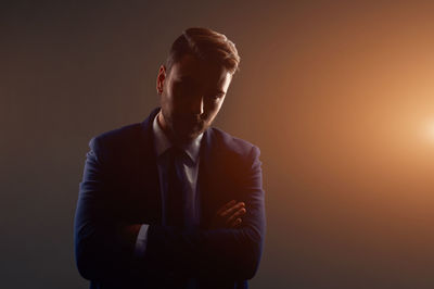 Man wearing mask against black background