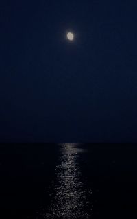 Scenic view of sea against clear sky at night