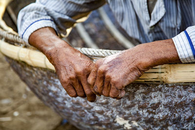 Midsection of man sitting in nautical vessel