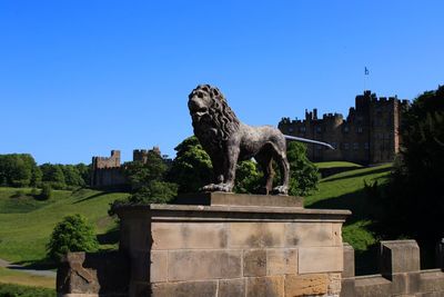 Statue of historic building against clear sky